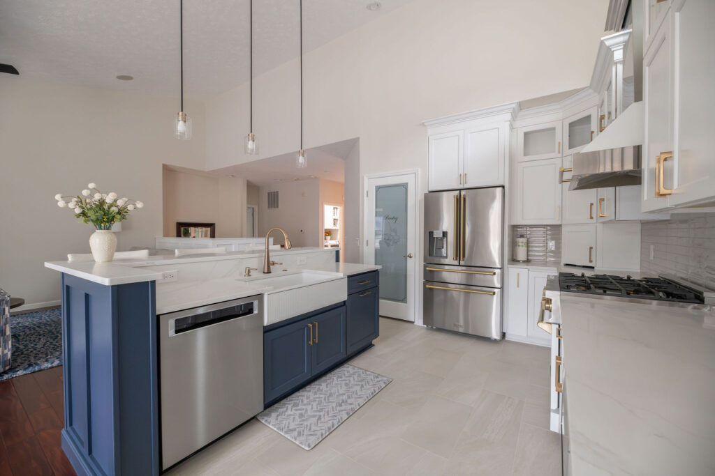 After of kitchen in Peninsula Ohio with Indigo Island, white cabinetry and countertops. Lindsey Putzier interior design 