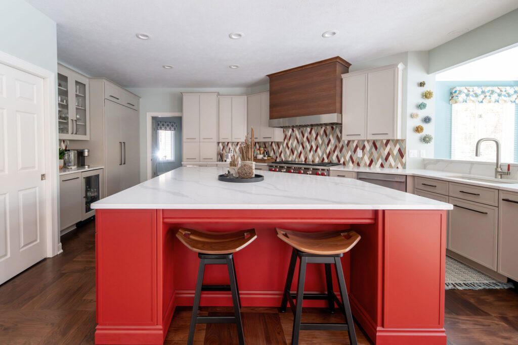 After of Kitchen remodel in Chagrin Falls, Ohio, with mosaic backsplash, red island and updated cabinetry. Lindsey Putzier interior design 