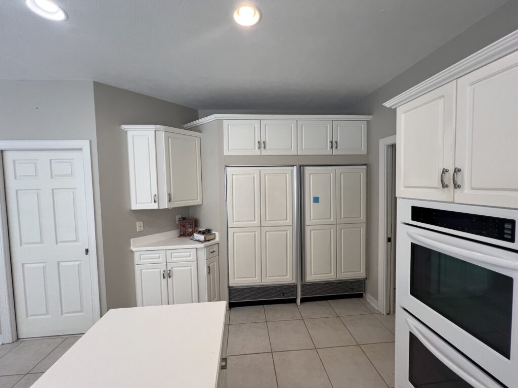 Before of fridge and pantry in the kitchen with dated style. Chagrin Falls ohio Lindsey Putzier interior design 
