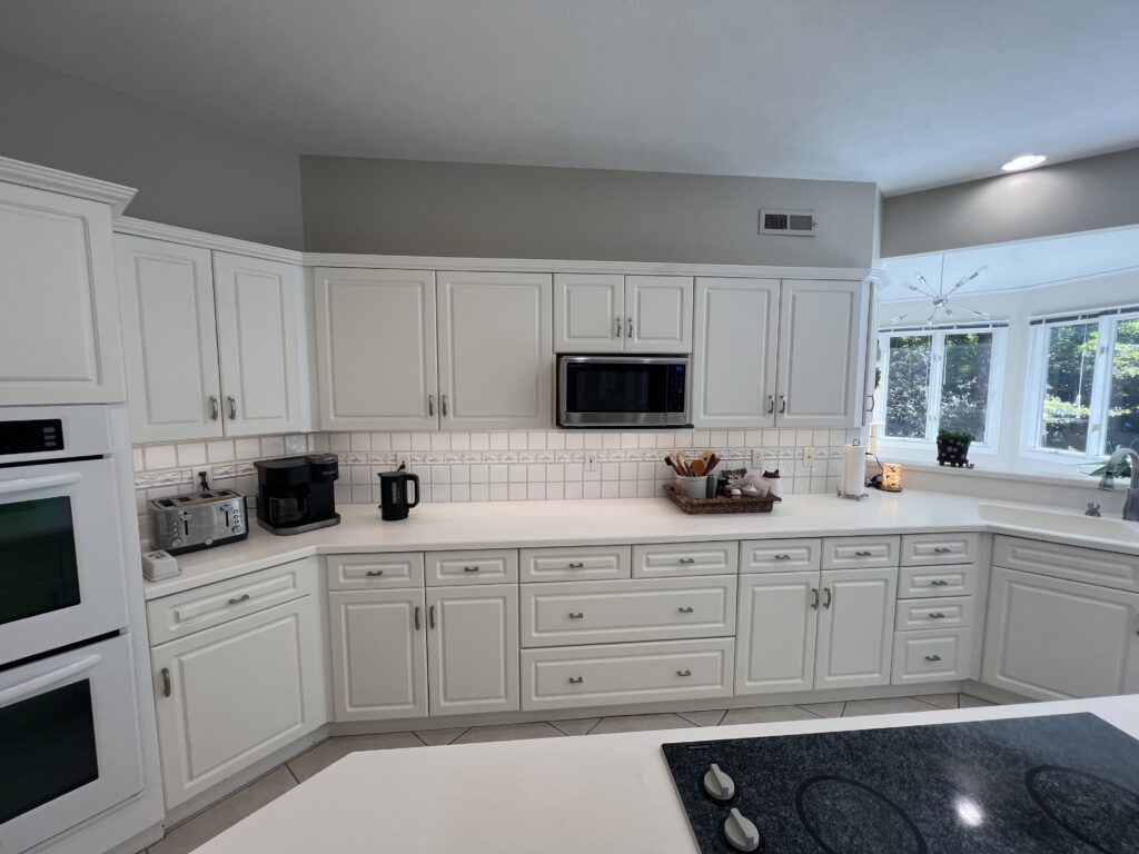 Before of the kitchen with white subway tile and dated cabinets. Lindsey Putzier interior design Chagrin Falls, Ohio 