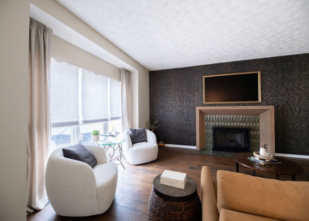 Family room with tiled accent wall, fireplace, large cozy chairs, sofa, and custom window treatments. Lindsey Putzier interior design Copley Ohio
