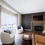 Family room with tiled accent wall, fireplace, large cozy chairs, sofa, and custom window treatments. Lindsey Putzier interior design Copley Ohio