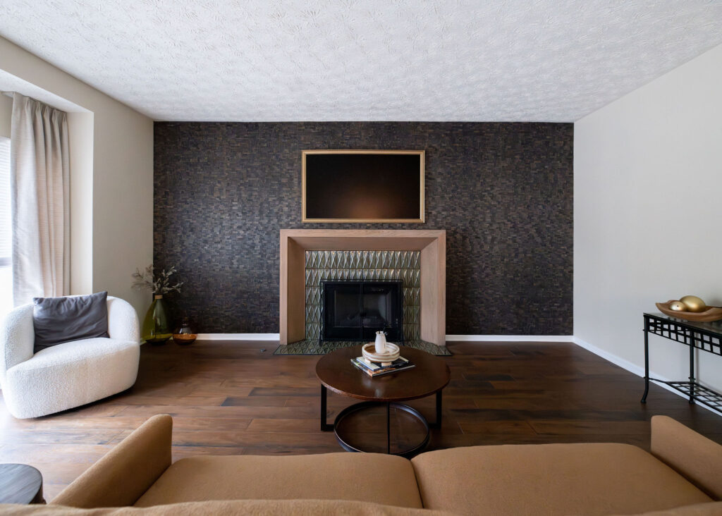 After of the redesigned living room with tiled accent wall, new fireplace and mantle. Lindsey Putzier interior design Copley Ohio 