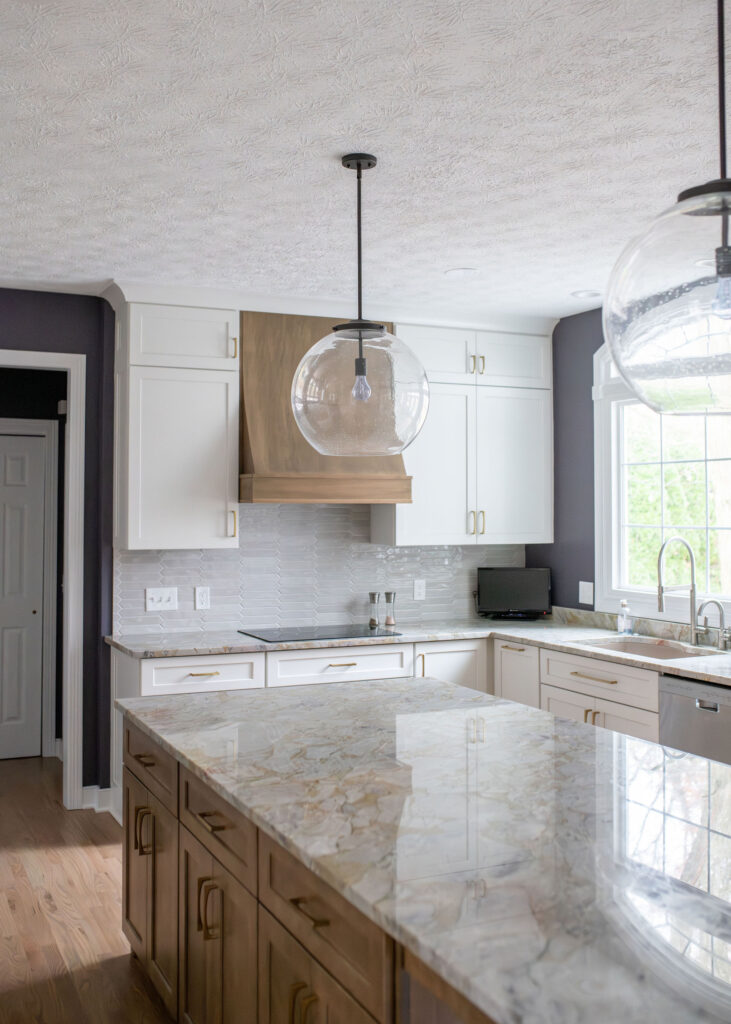 Pendant lighting over the granite island in the kitchen. Lindsey Putzier interior design Aurora Ohio
