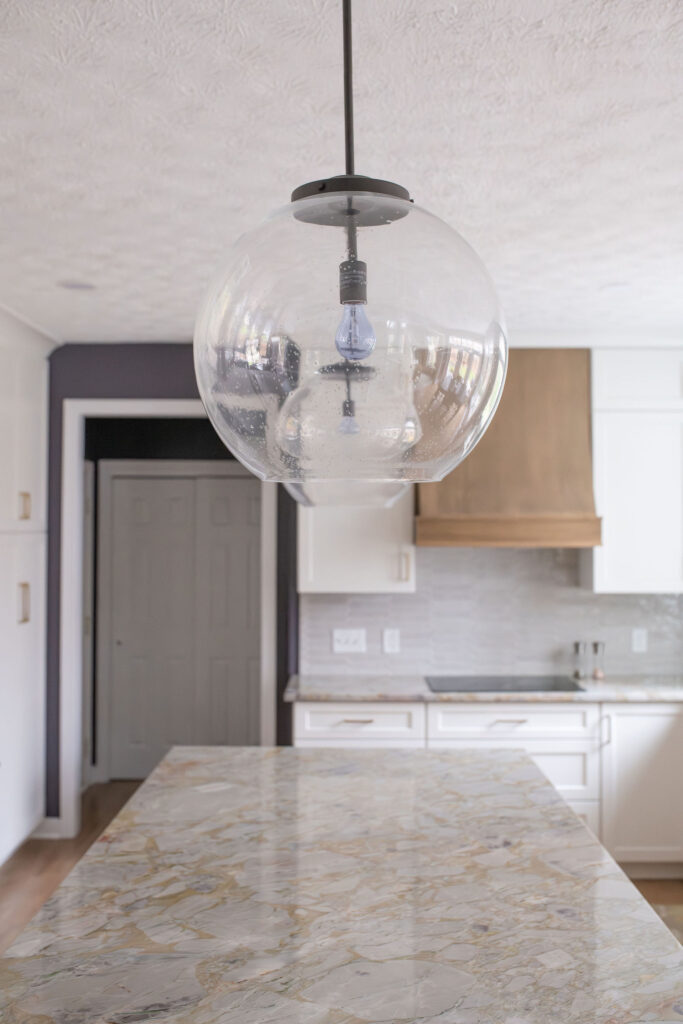 Pendant lighting over the granite island in the kitchen. Lindsey Putzier interior design Aurora Ohio