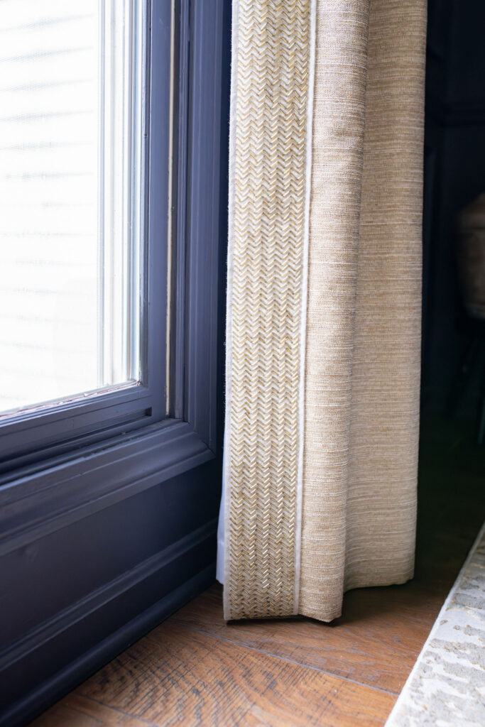 Custom window treatments in the dining room with dark hardwood flooring. Copley Ohio interior design Lindsey Putzier 