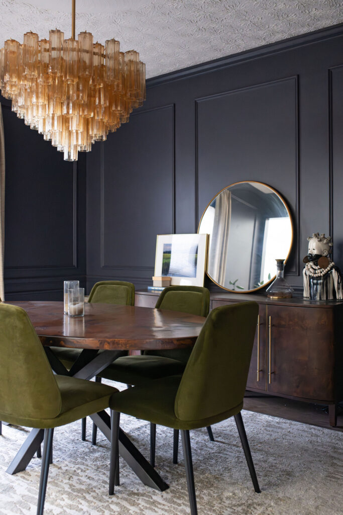 Dining room with dark green upholstered chairs and grey rug. Copley Ohio interior design Lindsey Putzier 