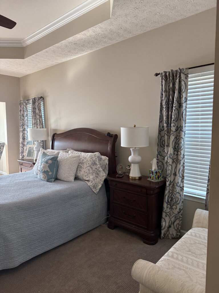 Before of the master bedroom with cream walls, grey patterned curtains. Peninsula Ohio Lindsey Putzier interior design 