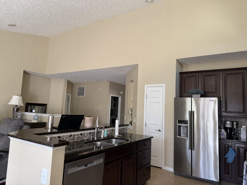 Before of the kitchen with dark cabinetry and countertops. Lindsey Putzier interior design Penninsula Ohio