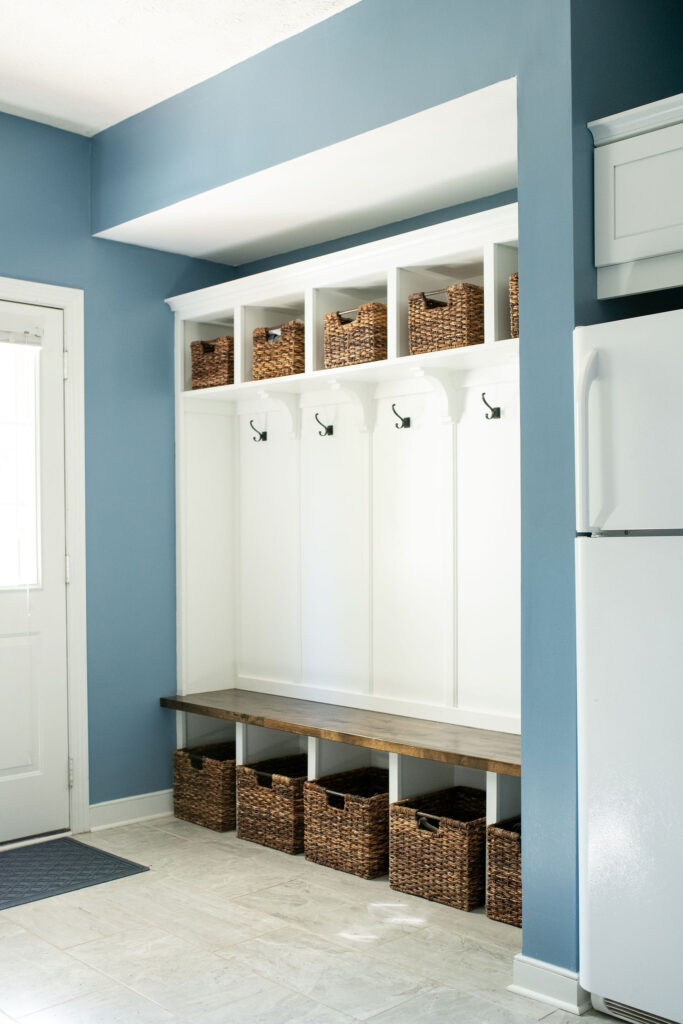 Custom Built in storage in the mudroom with bench for sitting, hooks for jackets and additional bins. Lindsey Putzier interior design