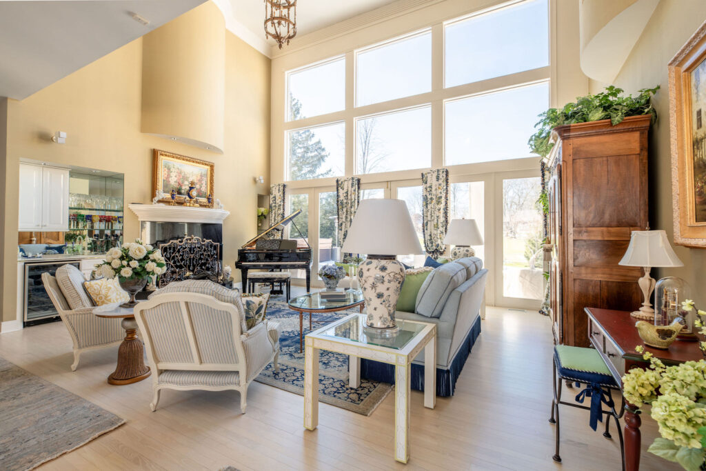 Living room in Aurora Ohio with french inspired design, custom furniture, window treatments, and design elements. Lindsey Putzier interior design 