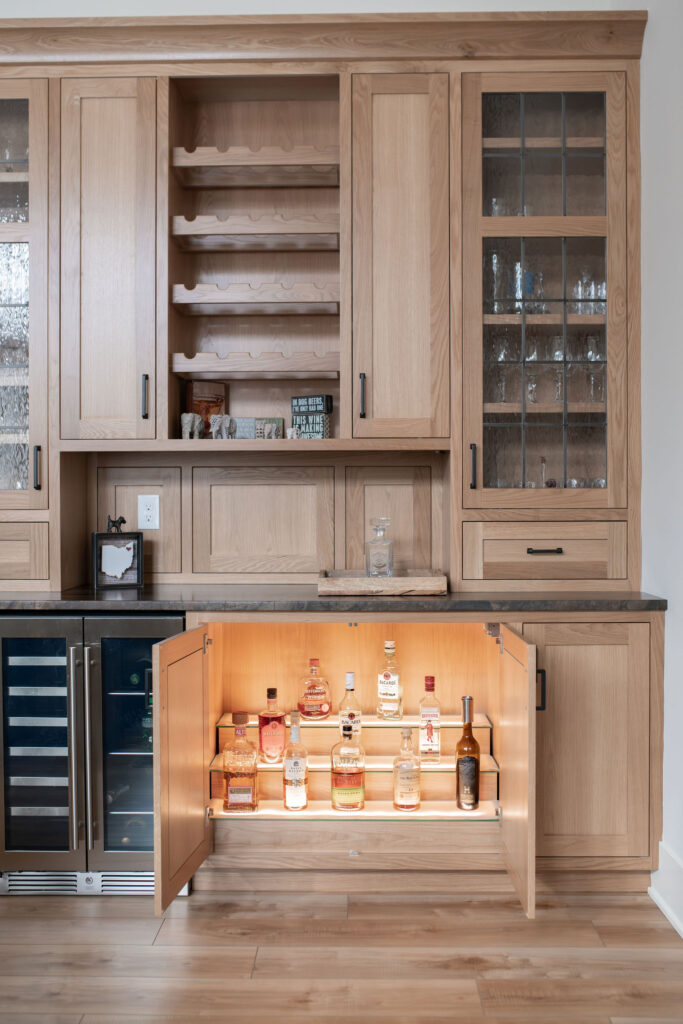 In home bar with liquor storage tucked away in the cabinet. Lindsey Putzier interior design 