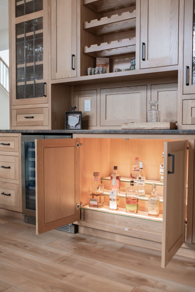 Custom in kitchen bar storage, tucked away in a cabinet. Lindsey Putzier interior design 