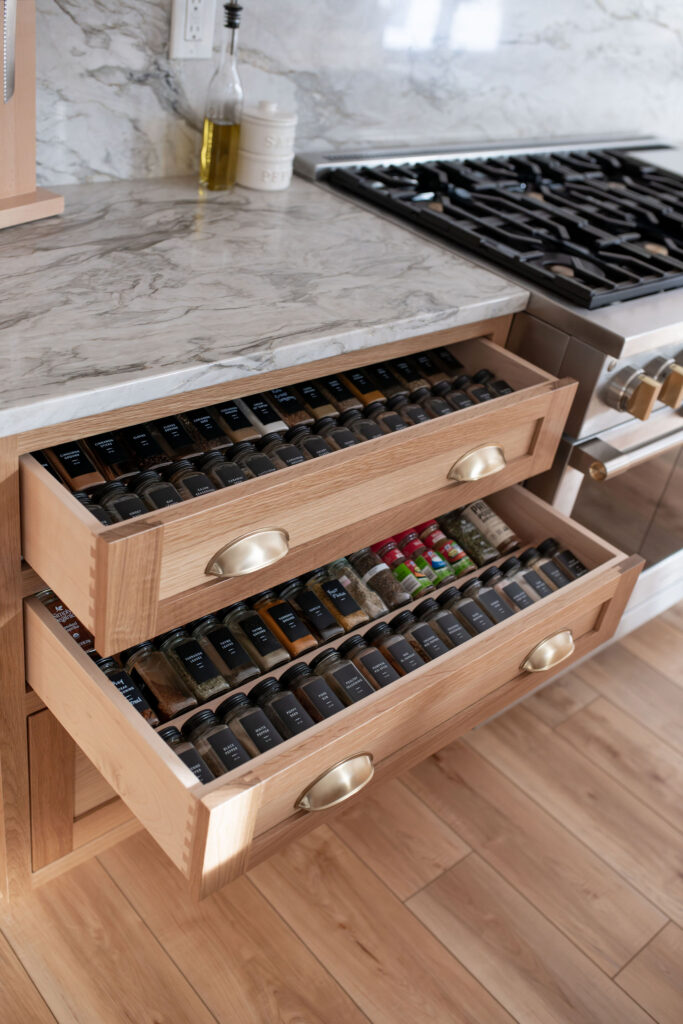 Spice drawers in the kitchen to tuck away bottles but keep them within close reach when needed. Lindsey Putzier interior design