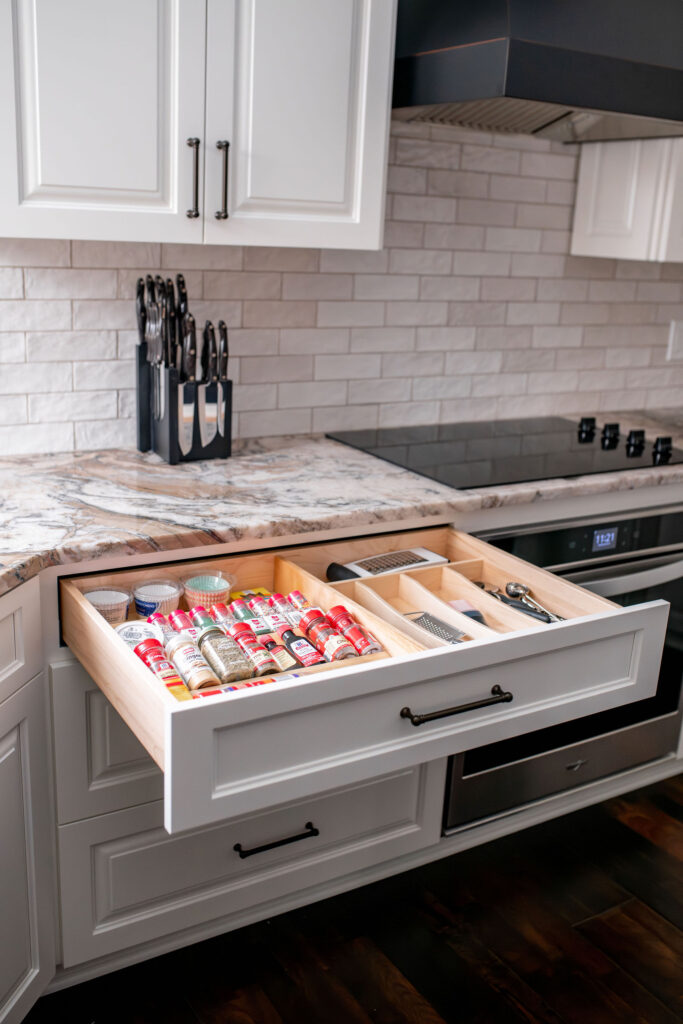 Spice drawers in the kitchen to tuck away bottles but keep them within close reach when needed. Lindsey Putzier interior design