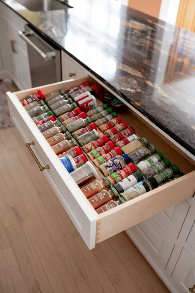 Spice drawers in the kitchen to tuck away bottles but keep them within close reach when needed. Lindsey Putzier interior design