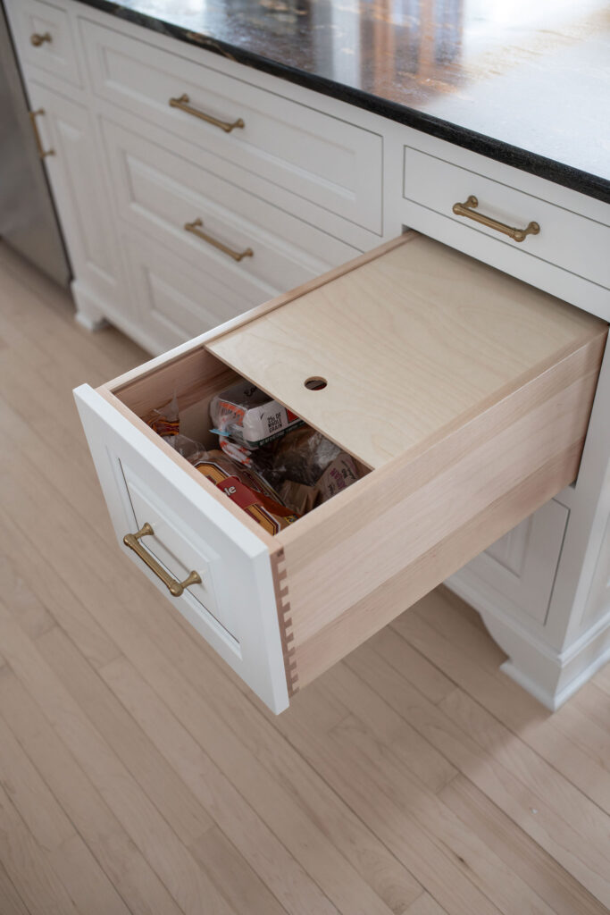 Bread drawer in the kitchen with insert to keep drawer dark but holes to keep it breathable. Lindsey Putzier interior design