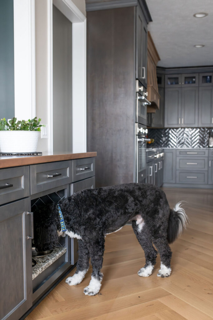 Built in dog bowl drawer in the kitchen to seemlessly feed dog without compromising style. Lindsey Putzier interior design