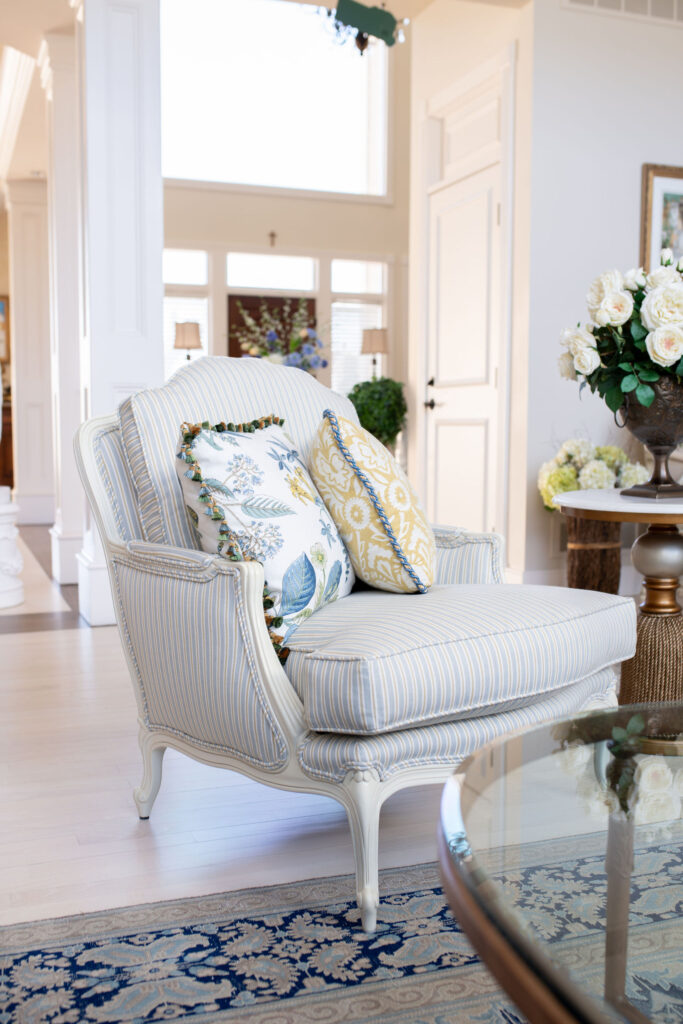 Custom chair in the living room with custom pillows with fringe trim. Aurora Ohio Interior design 