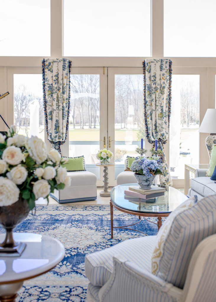 Living room in Aurora Ohio with french inspired redesign, updated furniture, custom window treatments, and vintage rug. Lindsey Putzier interior design 