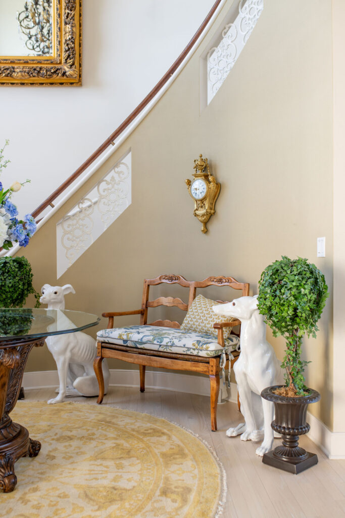 Updated cushion in Aurora Ohio Foyer with floral blue pattern and yellow accent pillow. Lindsey Putzier interior design 