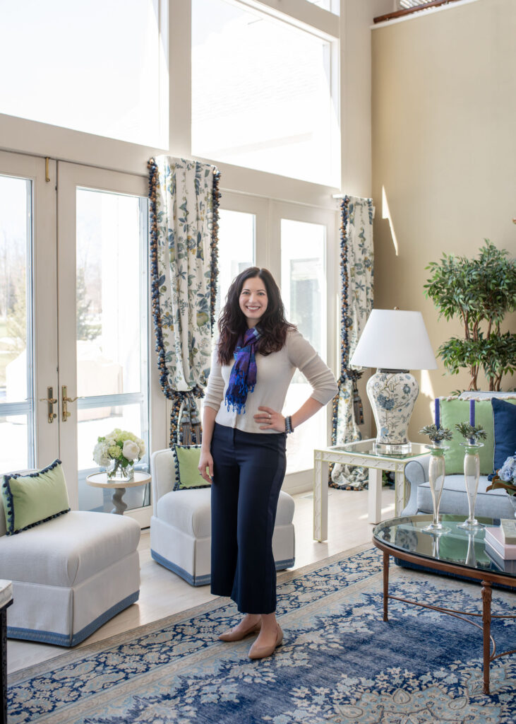Owner and principle designer Lindsey Putzier in the living room of french inspired Aurora Ohio Home. Interior design