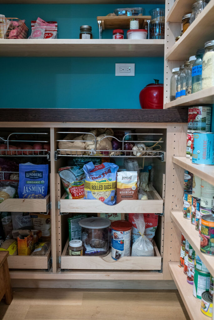 Specialty storage in the pantry with vegetable storage, bread storage, and open shelving. Lindsey Putzier interior design
