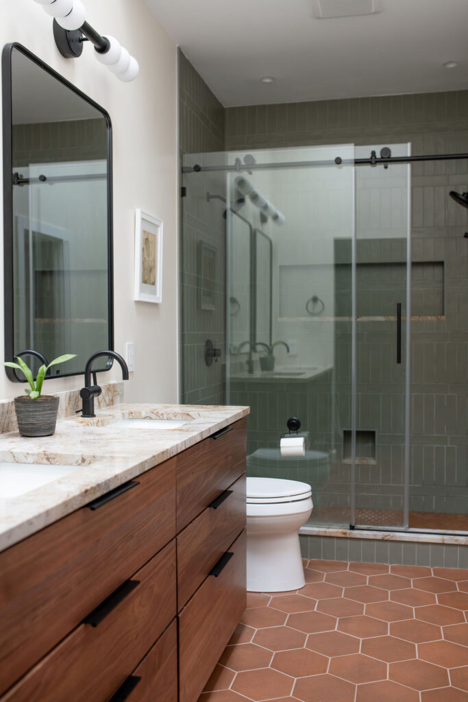 After of the master bedroom with glass updated shower, marble countertops, and tiled flooring. Lindsey Putzier interior design Akron Ohio 