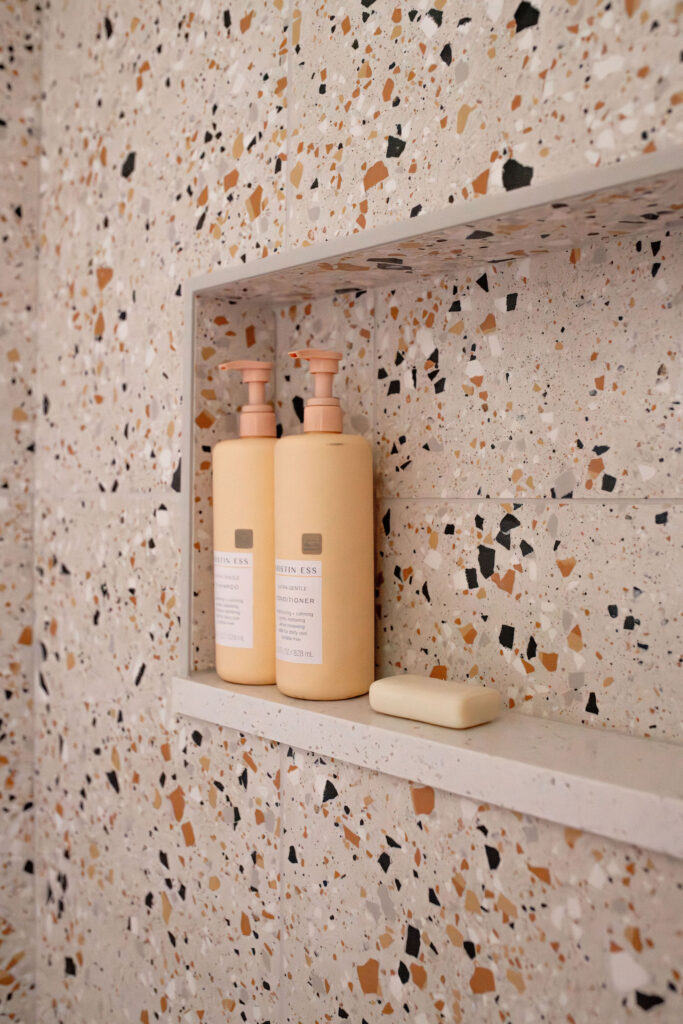 Secondary bathroom shower with unique tile, and built in shelf. Lindsey Putzier interior design Akron Ohio 