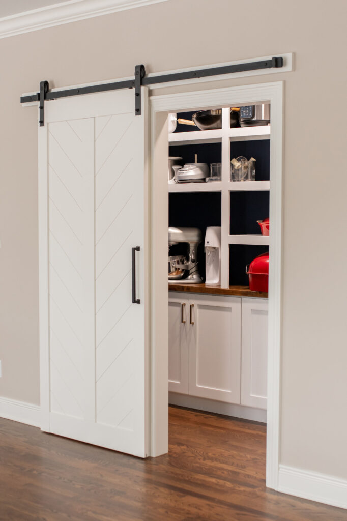 Sliding barn door entrance to the butlers pantry. Lindsey Putzier interior design 