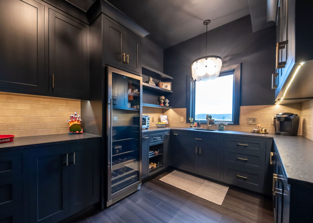 Large butlers pantry with sink, stainless steel appliances and storage tucked away from the kitchen. Lindsey Putzier interior design 