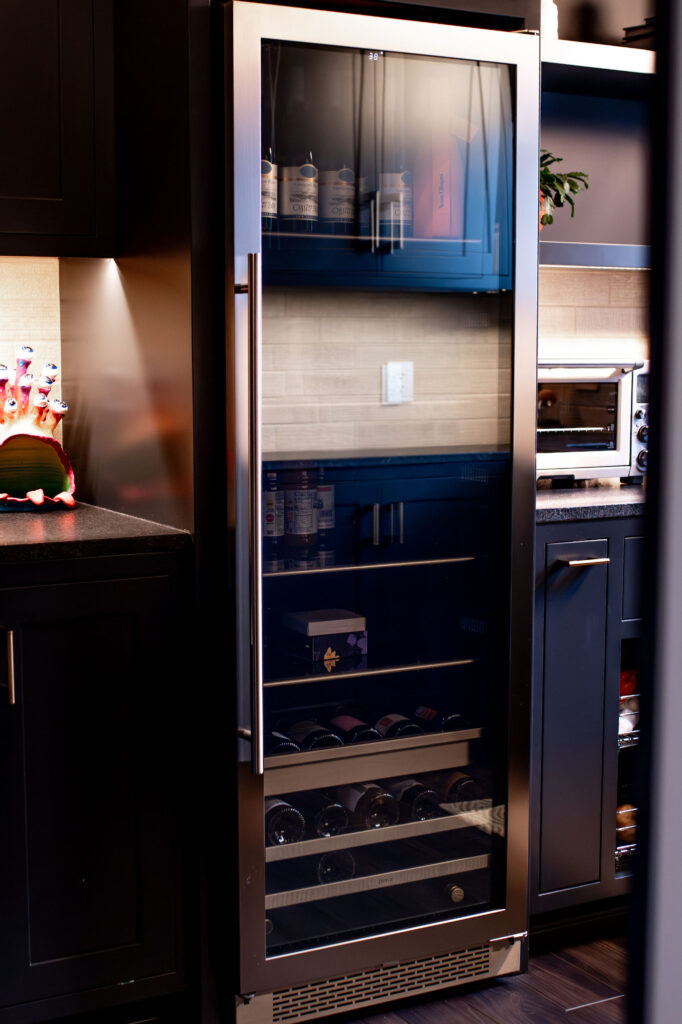 Butler Pantry wine fridge with dark cabinetry, silver appliances and recess lighting. Lindsey Putzier interior design 