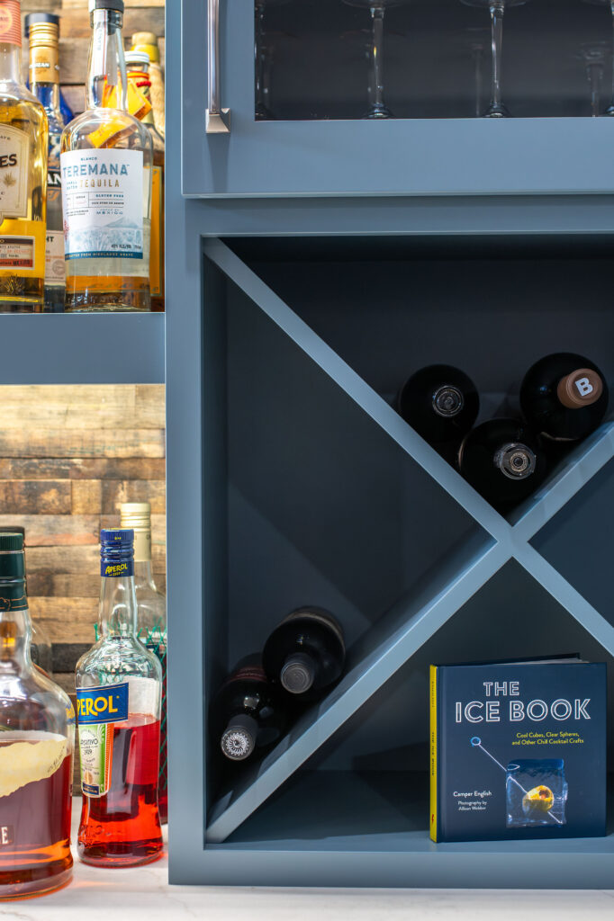 In home bar with built in wine cubbies for bottle storage. Lindsey Putzier interior design 