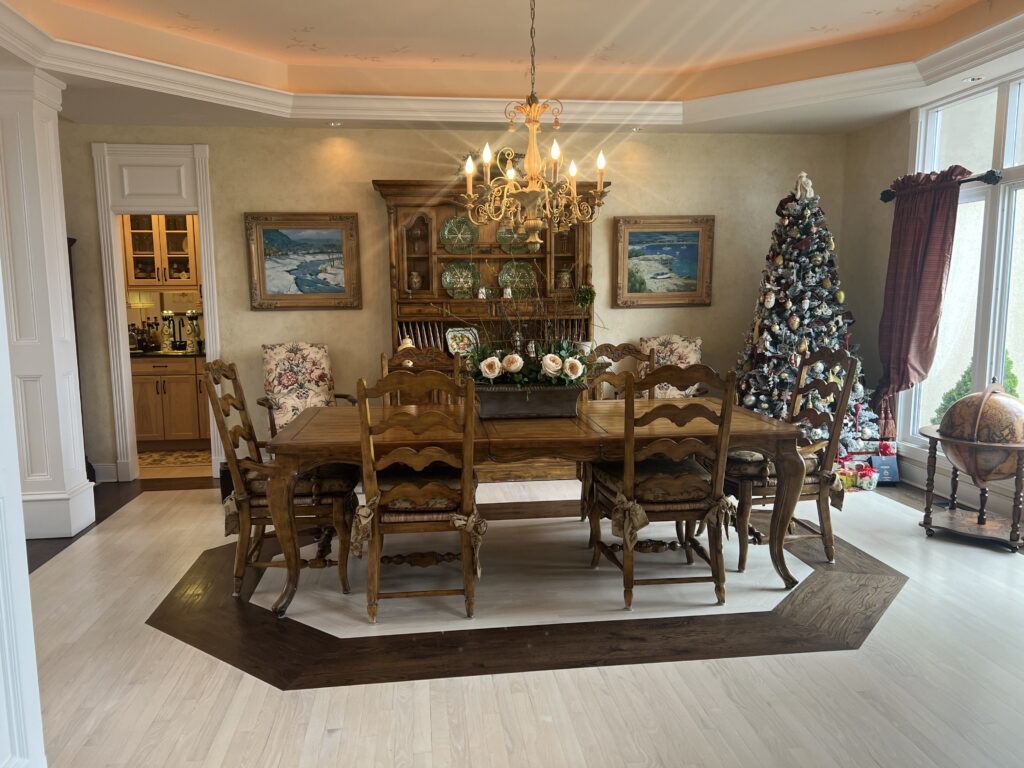 Before of the dining room with warm wooden furniture and red and rose gold accents. Aurora Ohio Interior design Lindsey Putzier 