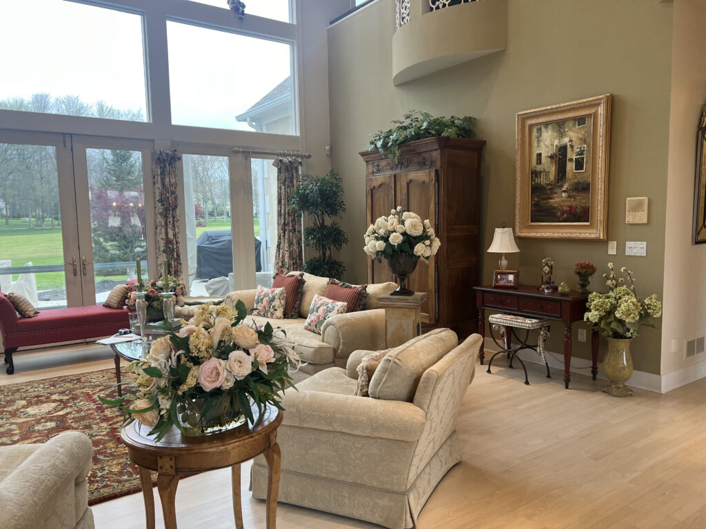 Before of the living room with warm colors and red color pallete. Aurora Ohio interior design Lindsey Putzier 