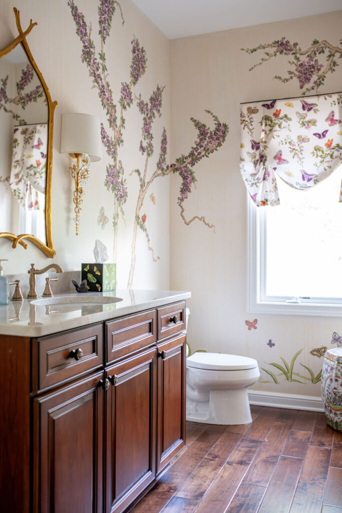 Powder room with wallpaper, accent mirror and wooden vanity. Lindsey Putzier interior design Hudson Ohio 