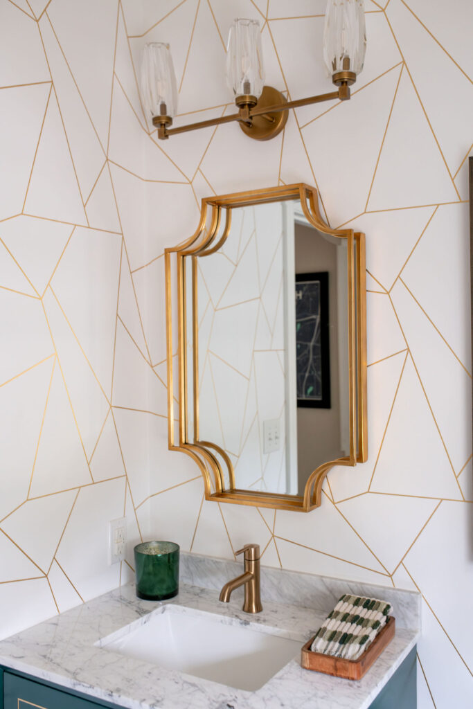 Overhead gold lighting in the powder room. Lindsey Putzier interior design Hudson Ohio 