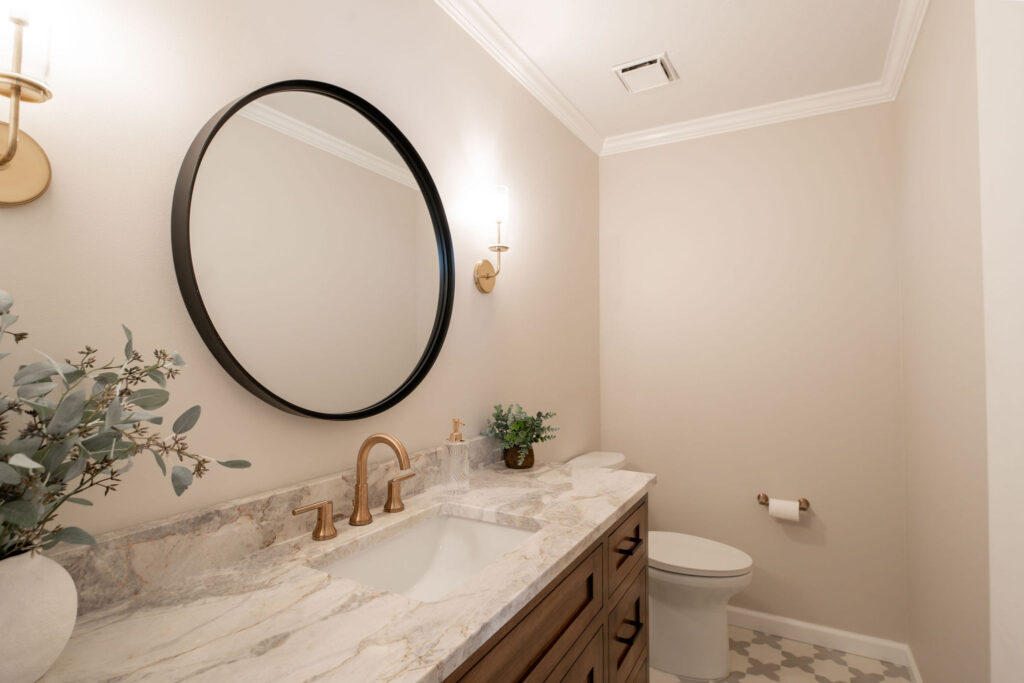 Main floor powder room in Hudson Ohio with updated countertops and lighting. Lindsey Putzier interior design 