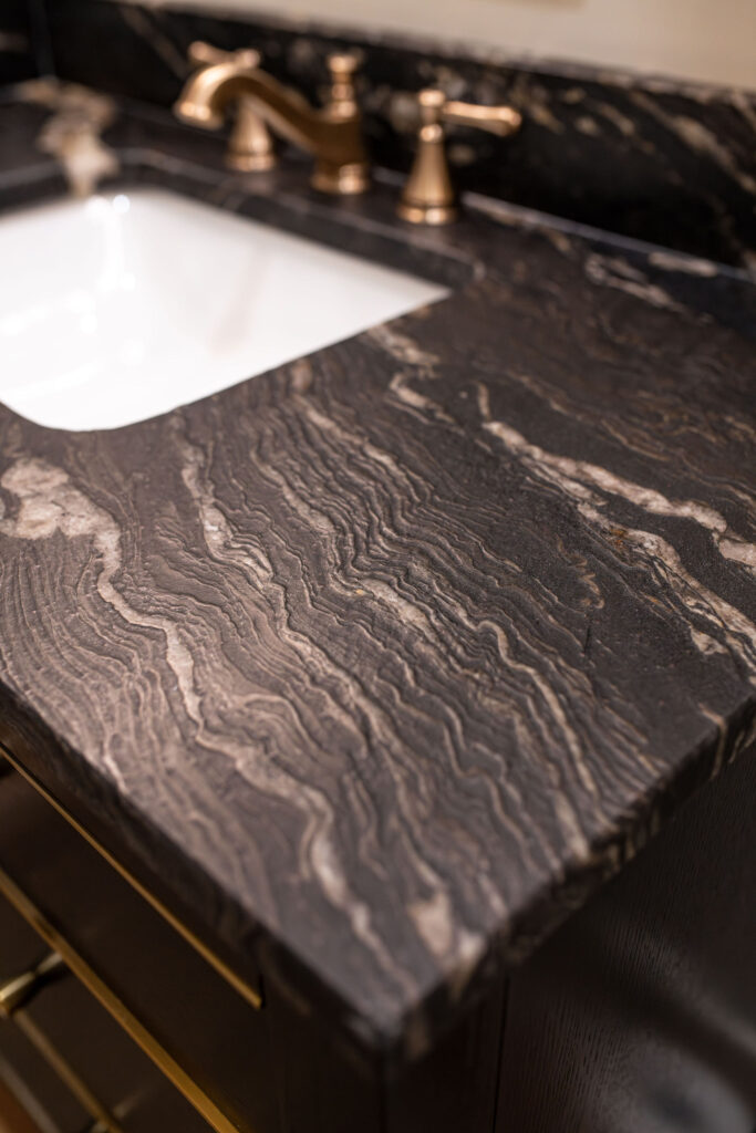 Black textured countertops in the powder room. Lindsey Putzier interior design Hudson Ohio 