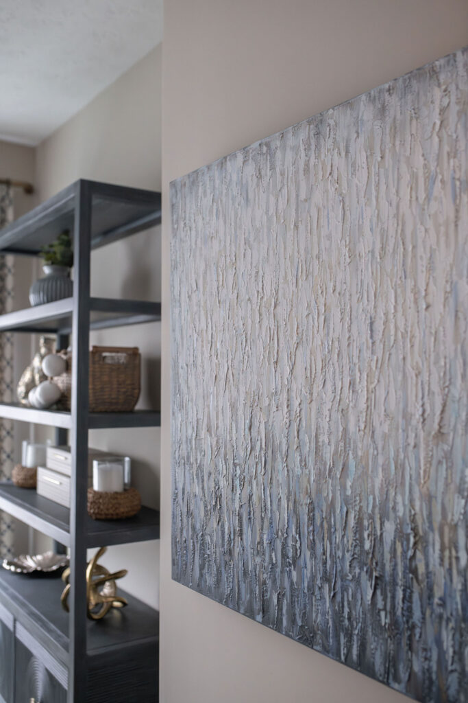 mixing textures in the home office with large painting on the wall besides a bookshelf. Lindsey Putzier interior design Hudson Ohio 
