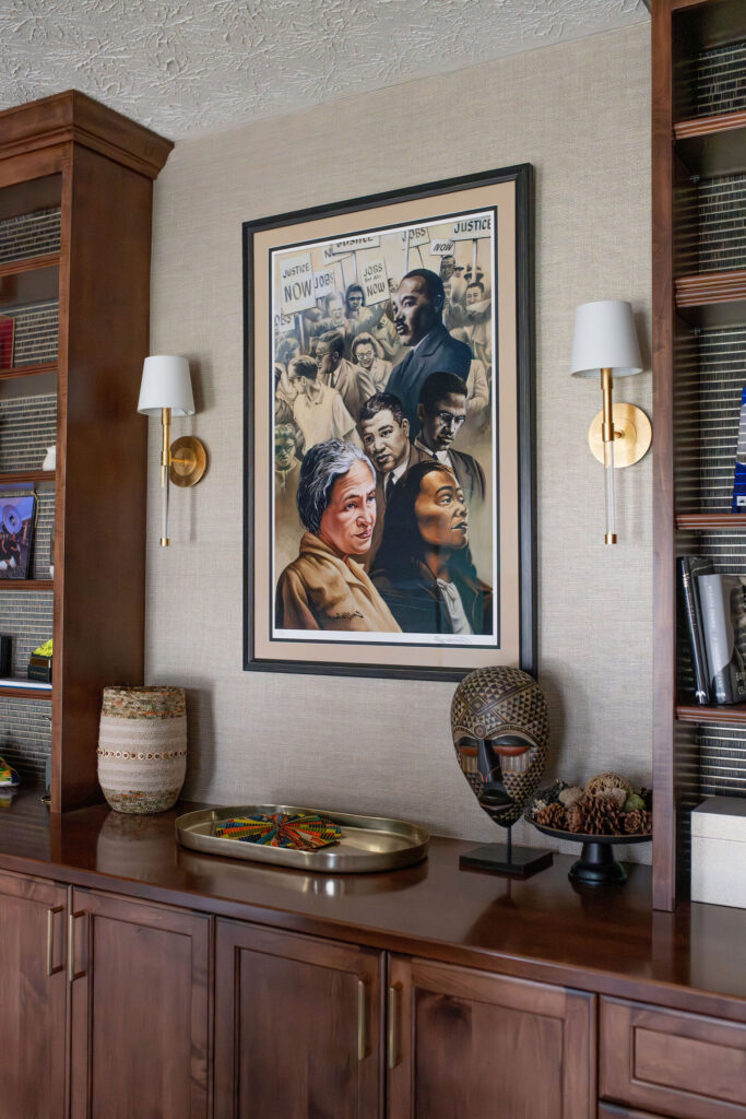 Art in the home office with deep wooden built ins and gold sconces on the walls. Lindsey Putzier interior design Hudson Ohio  