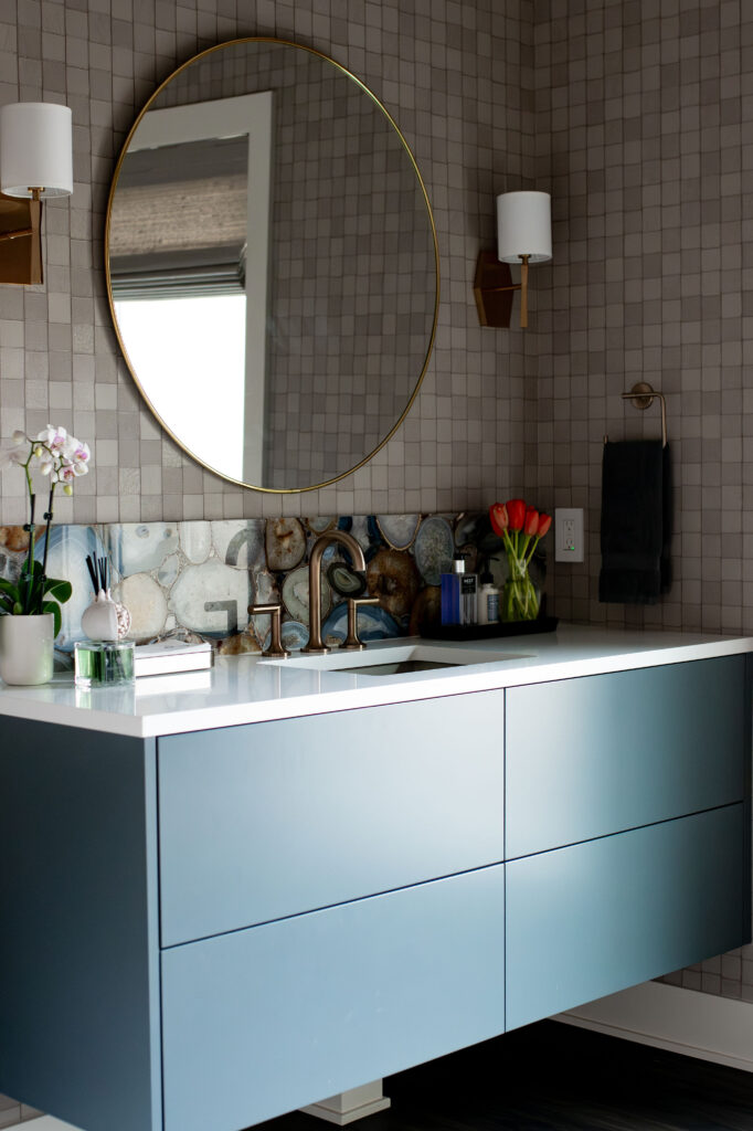 Painted vanity in the powder room with white countertops. Lindsey Putzier interior design Hudson Ohio 