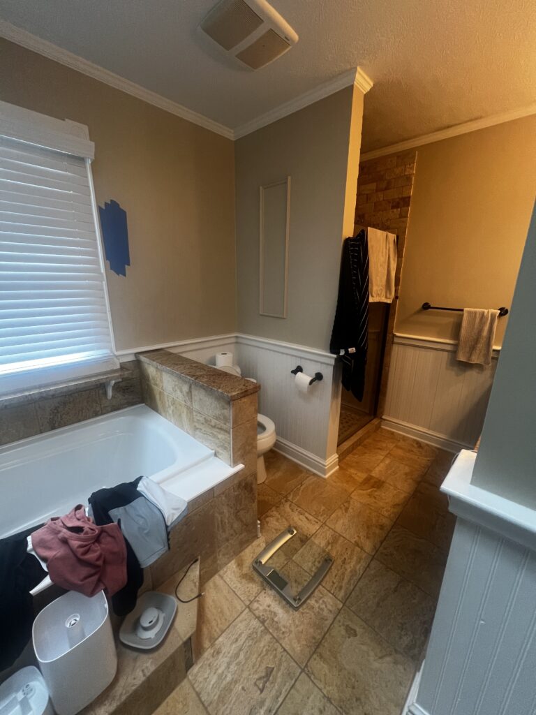 Before of the Master bathroom in Hudson Ohio with awkward layout with toilet squished between the tub and shower. Lindsey Putzier interior design 