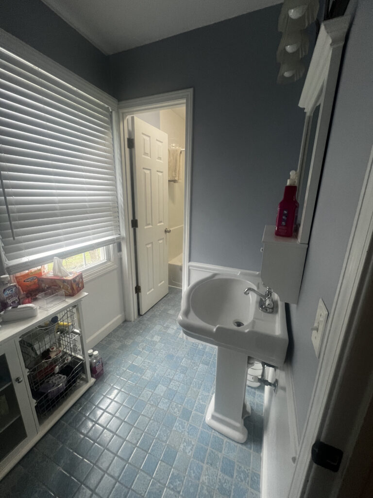 Before of the kids bathroom with white finishes and dated fixtures. Lindsey Putzier interior design Hudson Ohio 