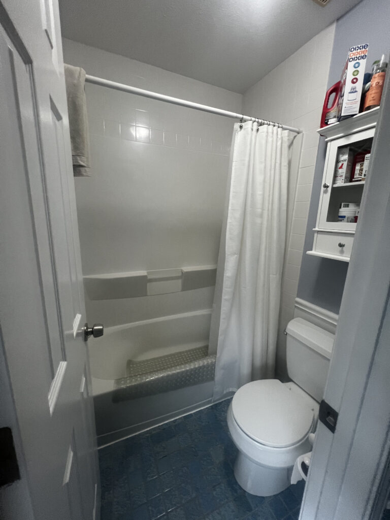 The shower before in a completely separate room in the kids bathroom. Lindsey Putzier interior design. 