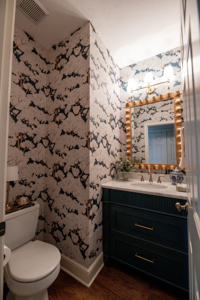 After of the powder room with floral wallpaper, and golden accents. Lindsey Putzier Interior Design Aurora Ohio  