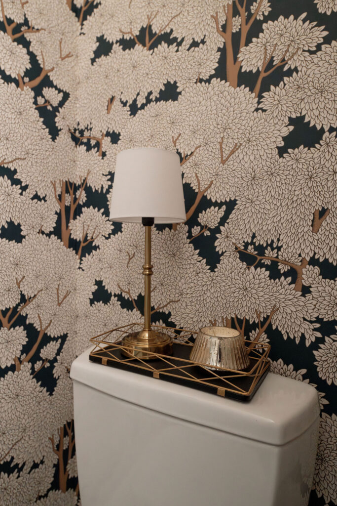 After of the powder room with floral wallpaper, and golden accents. Lindsey Putzier Interior Design Aurora Ohio  