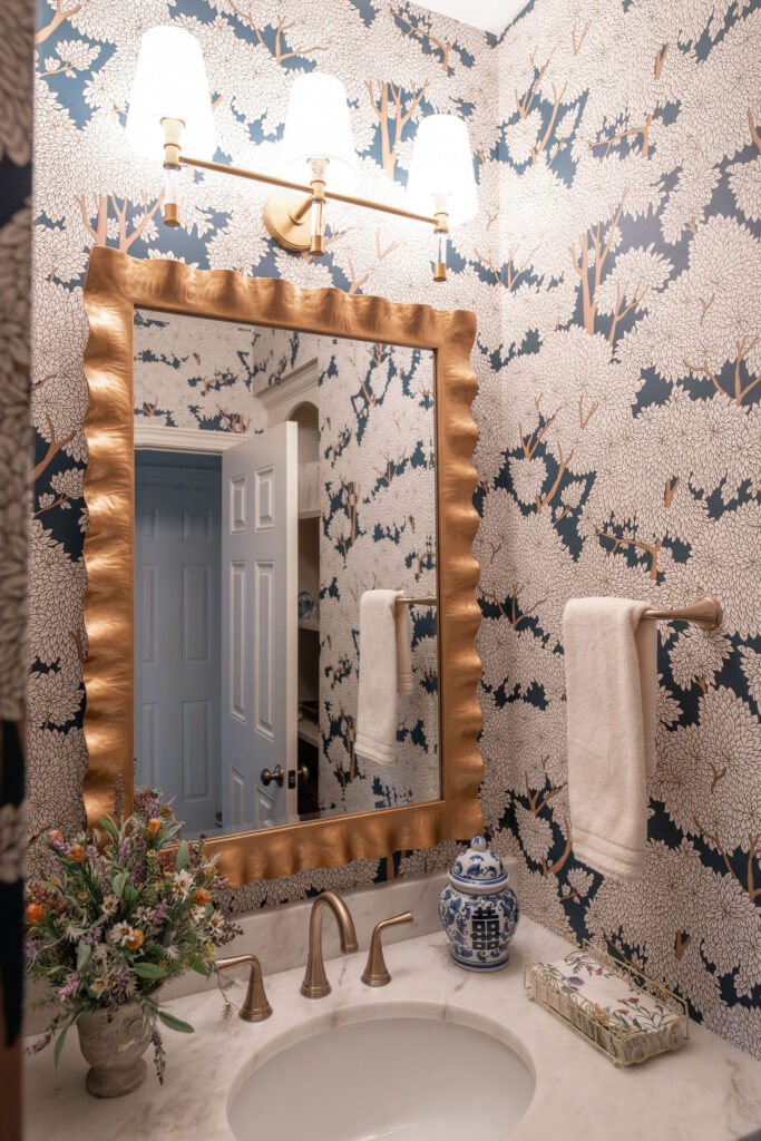 After of the powder room with floral wallpaper, and golden accents. Lindsey Putzier Interior Design Aurora Ohio  