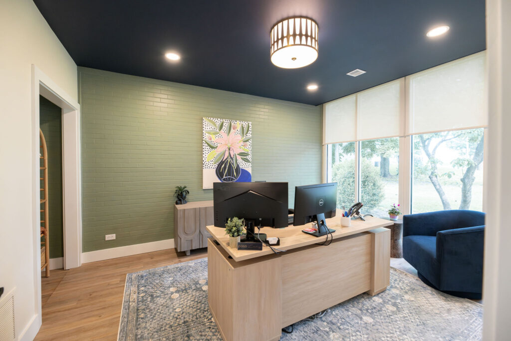 Executive office with floral artwork and sideboard. Cuyahoga Falls Ohio. Lindsey Putzier interior design
