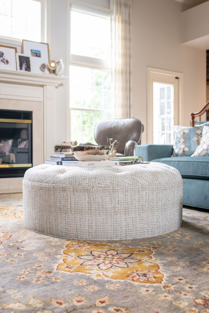 Ottoman in the living room with performance fabric, and vintage inspired rug. Lindsey Putzier Interior Design Aurora Ohio  